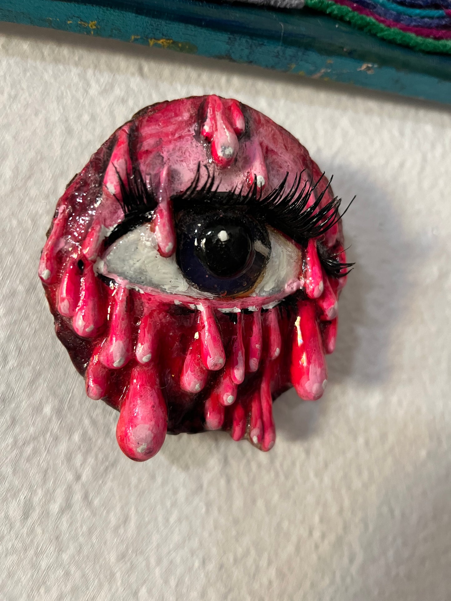 Pink dripping eye sculpture