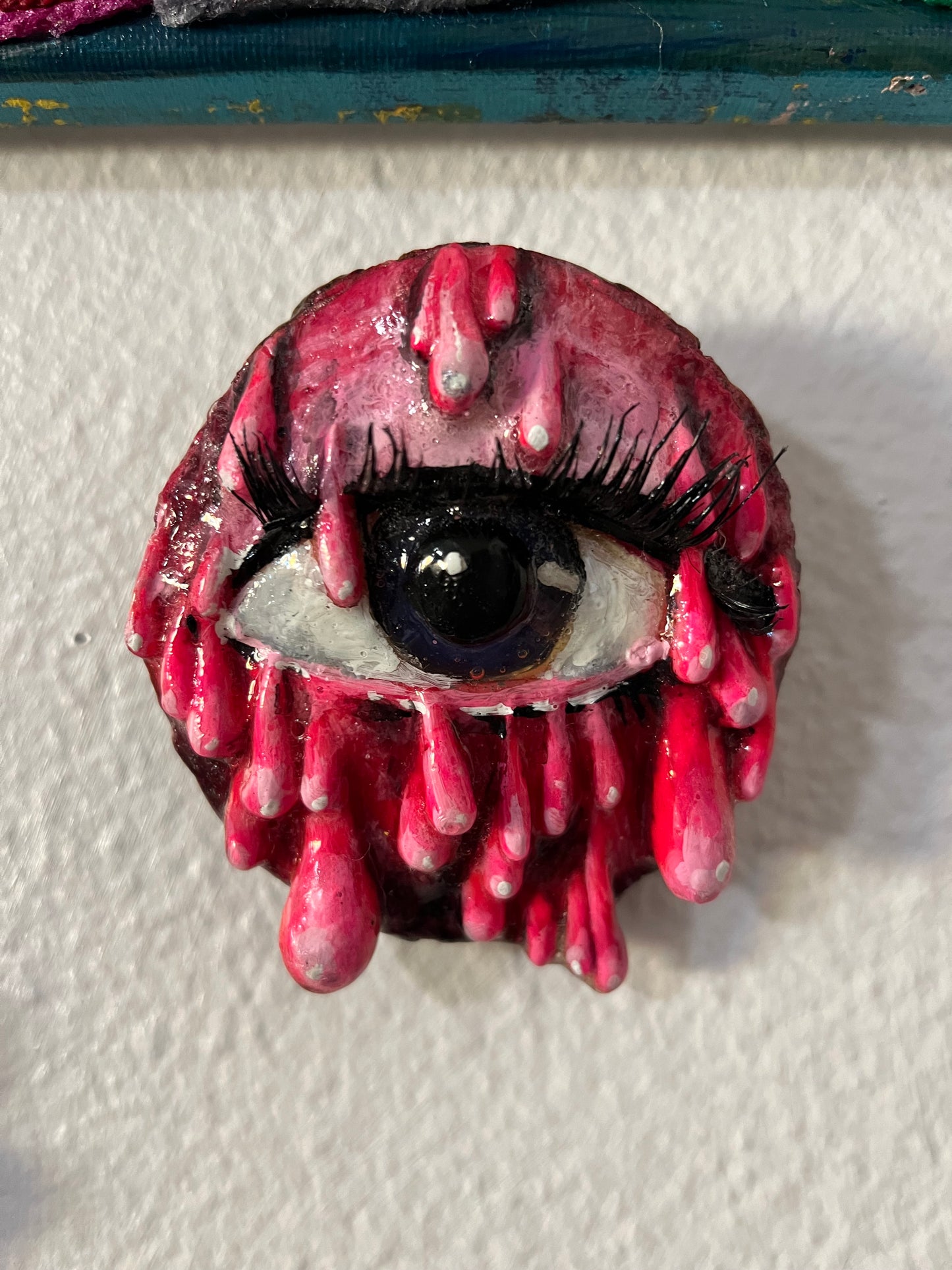 Pink dripping eye sculpture