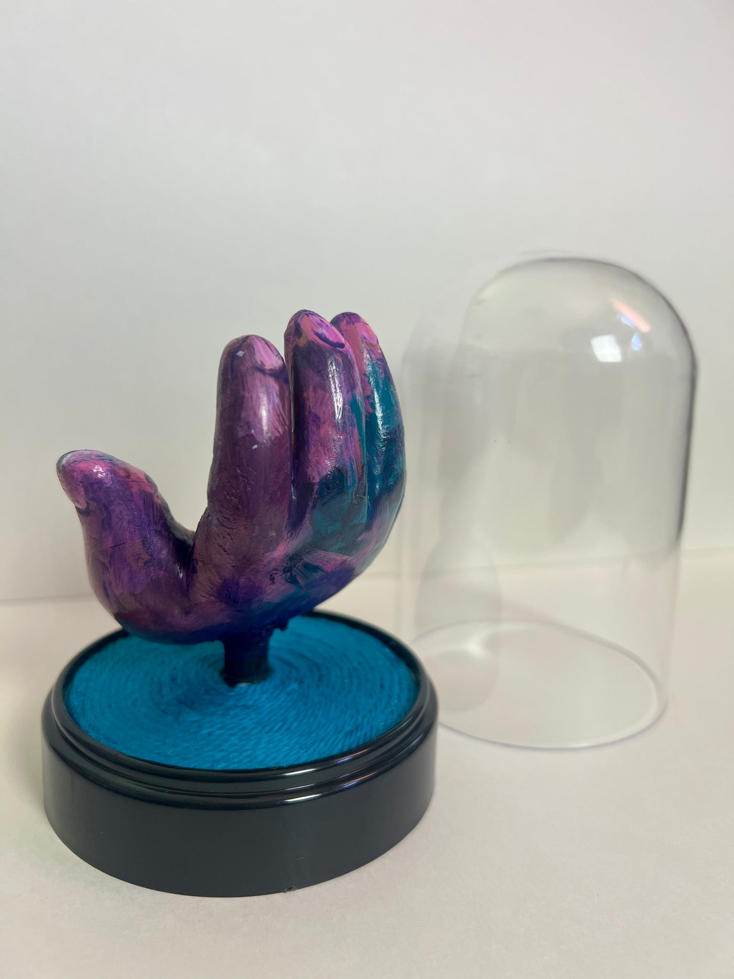 “Purple Eye” hand sculpture in cloche