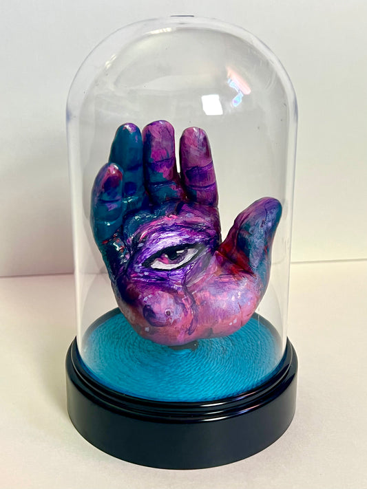 “Purple Eye” hand sculpture in cloche